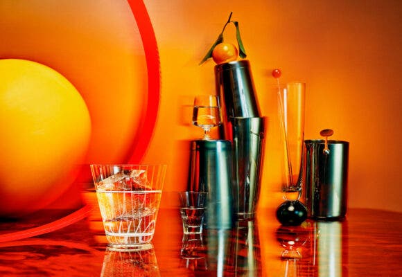 cocktail making ingredients next to a glass of sochu