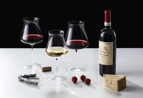 Wine Enthusiast wine glasses next to a bottle of wine and cheese